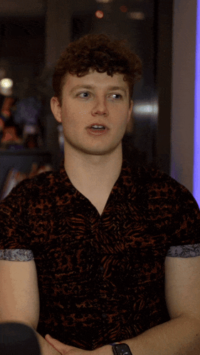 a young man with a name tag that says okay on it