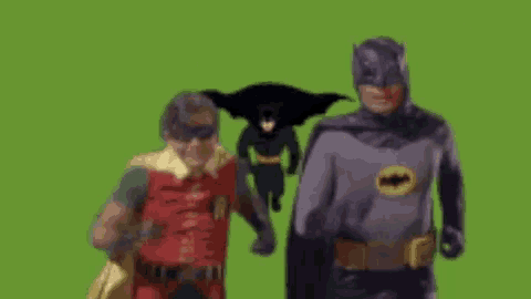batman and robin are standing next to each other on a green background .