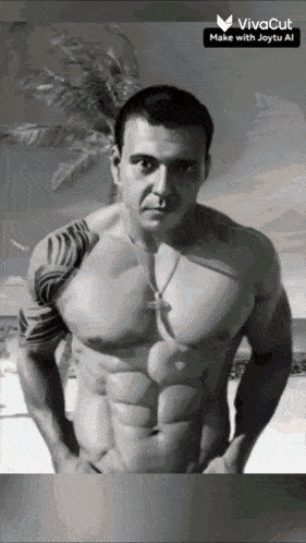 a black and white photo of a shirtless man with a tattoo