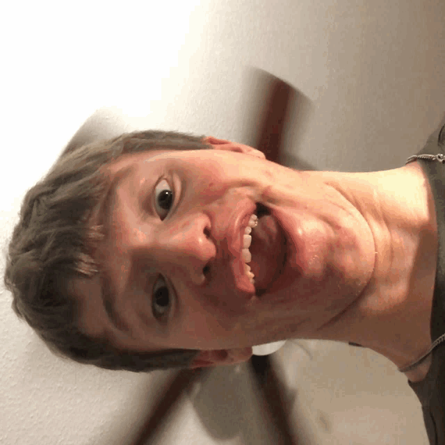 a young man making a funny face with his tongue hanging out