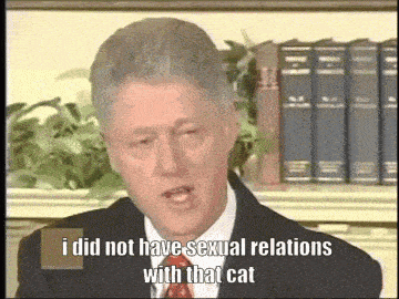 a man in a suit and tie is talking about sexual relations with a cat