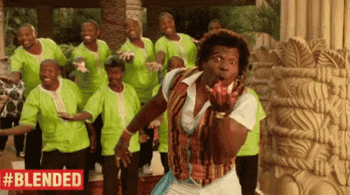 a group of men are dancing in front of a statue .