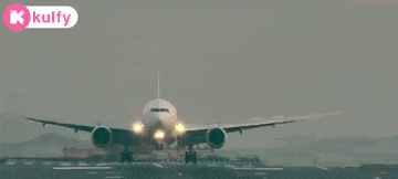 an airplane is taking off from an airport runway with a kolfy logo in the background