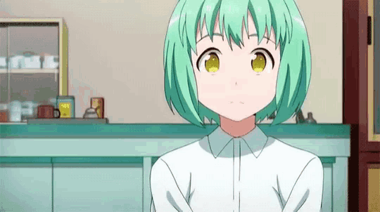 a girl with green hair and yellow eyes is standing in a kitchen .
