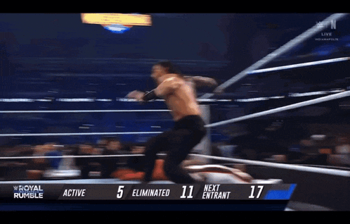 a wrestling match between roman reigns and kevin owens is going on