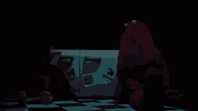 two stuffed animals are sitting in front of a refrigerator with a sticker that says ' elmo ' on it