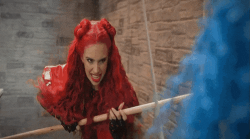 a woman with red hair is holding a blue object