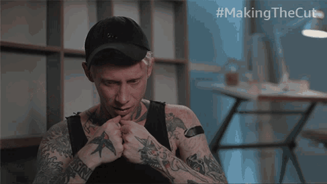 a man with a tattoo on his neck is making a funny face with the hashtag #makingthecut behind him