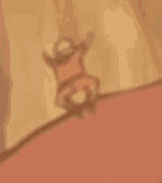 a blurred image of a cartoon character standing on a red carpet .