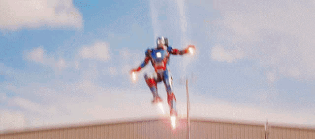 iron man is flying through the air with his arms outstretched .