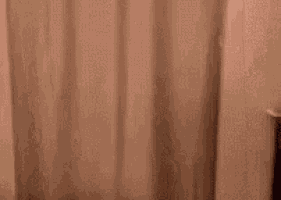 a blurry picture of a person standing in a doorway .