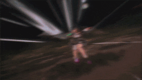 a blurred image of a person with a sword in their hand