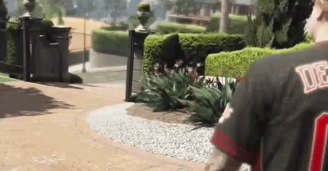 a man wearing a number 30 jersey is walking down a path
