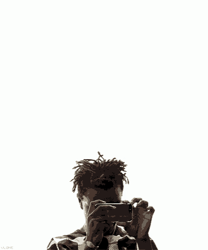 a man with dreadlocks and a necklace around his neck is looking down against a white background .