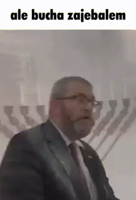 a man in a suit and tie is standing in front of a menorah with the words ale bucha zajebalem above him .