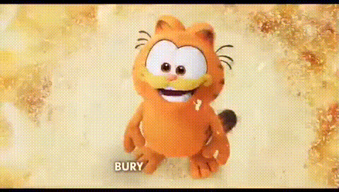 a cartoon cat named garfield is smiling while sitting on a table .