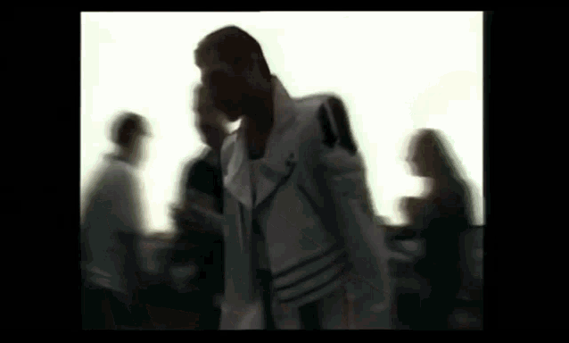 a blurry picture of a man in a white jacket