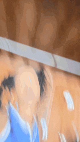 a blurry picture of a person wearing a blue swimsuit