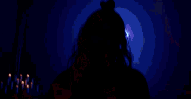 a woman is holding a pair of scissors in front of a neon cross ..