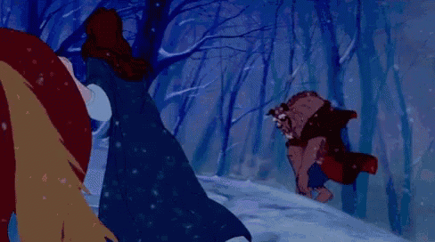 a woman is standing next to a horse in the snow in a forest .
