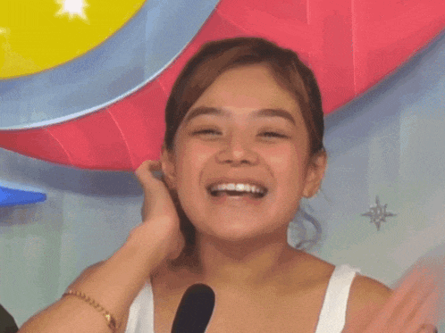 a woman wearing a white tank top with a sticker that says bianca