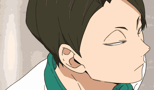 a close up of a person 's face with a green shirt