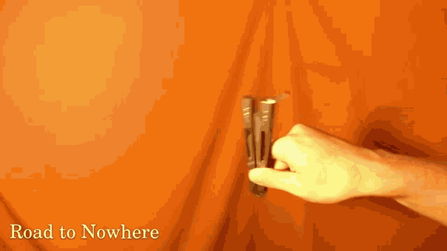 a person holding a cell phone with the words road to nowhere written below them