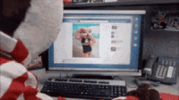 a teddy bear is looking at a computer screen with a picture of a teddy bear on it