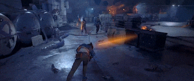 a person is doing a handstand in a video game while another person holds a lightsaber .