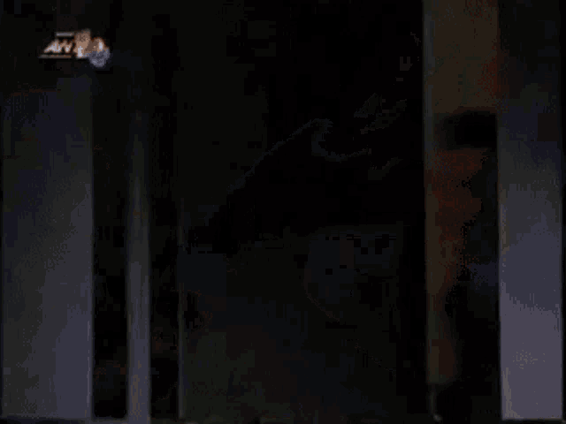 a man in a blue shirt is being punched in the face by another man