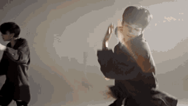 a couple of men are dancing together in a room .
