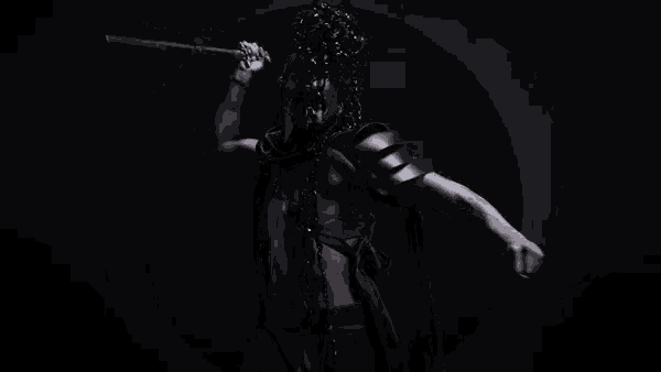 a man in a mask is holding a sword