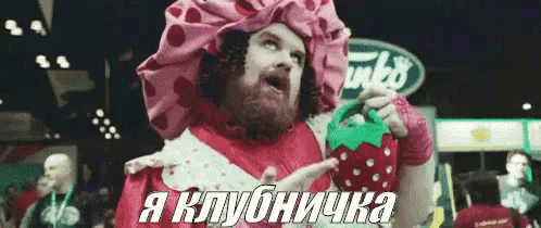 a man in a strawberry costume is holding a strawberry shaped container .