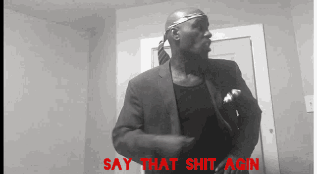 a man in a suit and tie says " say that shit again " in red
