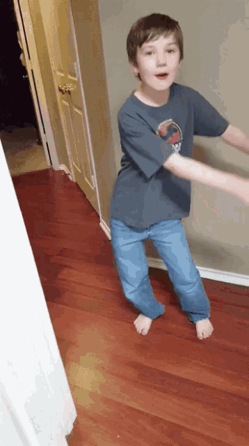 a young boy wearing a t-shirt that says ' spiderman ' on it