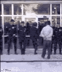 a group of police officers standing outside of a building .