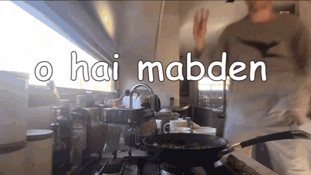 a man is cooking on a stove with the words hai madden behind him
