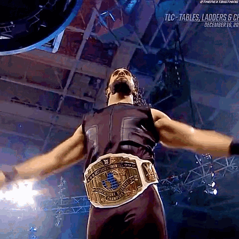 a man wearing a wrestling belt that says world heavyweight champions on it