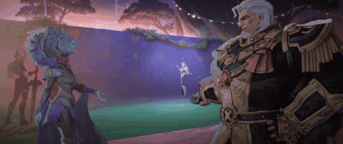 a man and a woman are standing next to each other in front of a purple wall