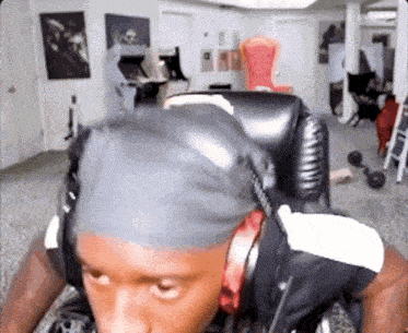 a man wearing headphones is sitting in a chair in a living room