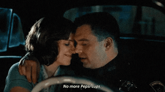 a man and woman are kissing in a car and the man is saying " no more pepsi cups "