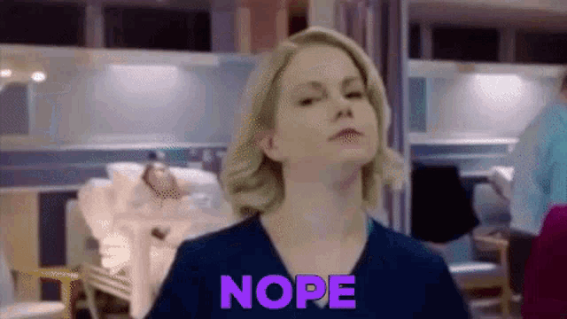 a woman in a hospital room with the word nope on her chest