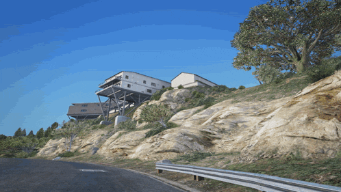 a large house sits on top of a rocky cliff