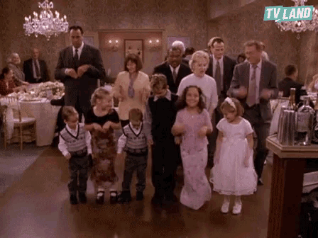 a group of children are dancing in a room with a tv land logo on the bottom
