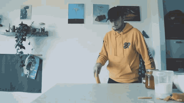 a man wearing a yellow hoodie that says gp on it