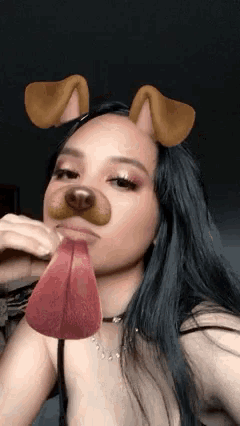 a woman wearing a dog mask with her tongue out