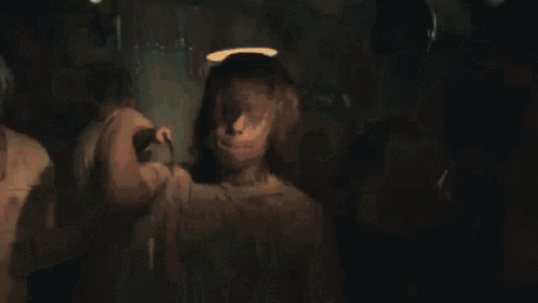 a woman is covering her face with her hands while another woman holds her .