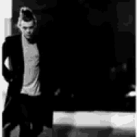 a black and white photo of a man in a jacket