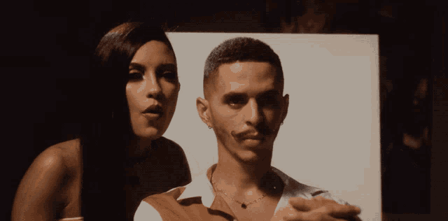 a man and a woman are posing for a photo