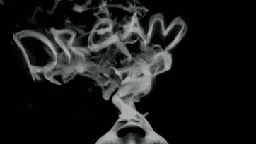 a person is smoking a cigarette and smoke is coming out of their mouth .